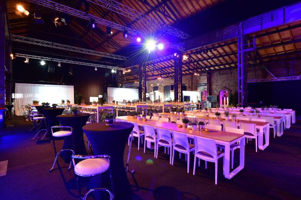 Bestuhlte Veranstaltung in der Industriekathedrale Alte Schmelz mit stimmungsvollem Licht.